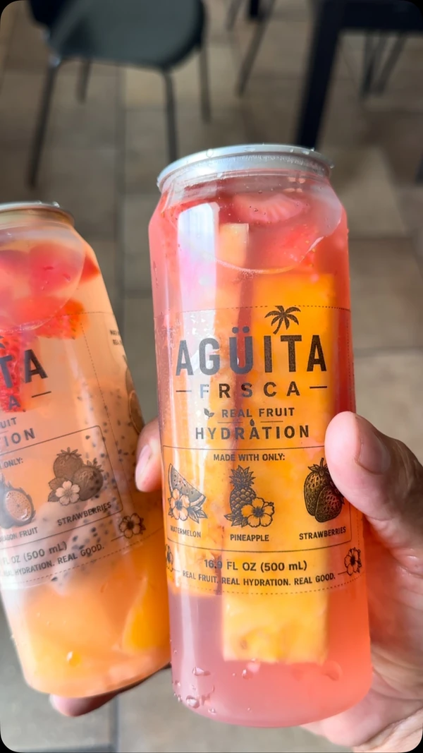 Two fruit-filled Agüita FRSCA drinks ready to share