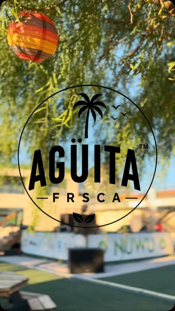 The Agüita FRSCA palm-tree logo on glass at a Las Vegas community event