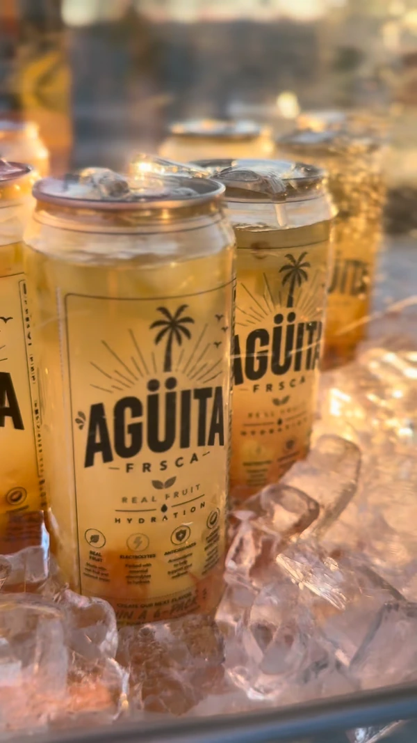 Golden yellow Agüita FRSCA cans chilled on ice
